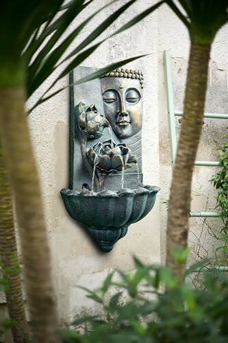 Buddha wall fountain in a garden setting