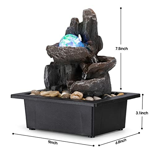 Desktop water fountain with LED light and rocks.